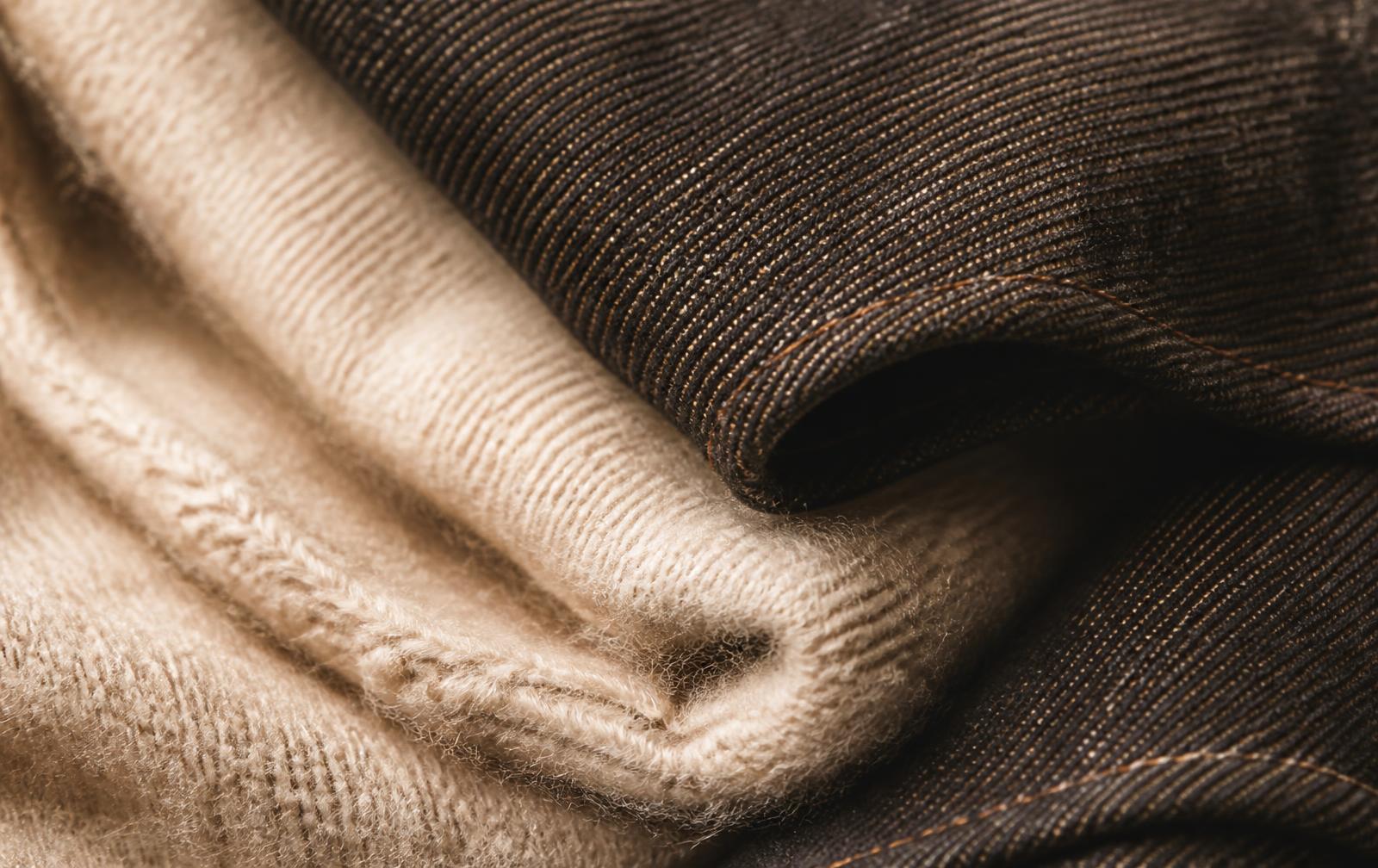 Close-up of merino wool and raw denim fabric